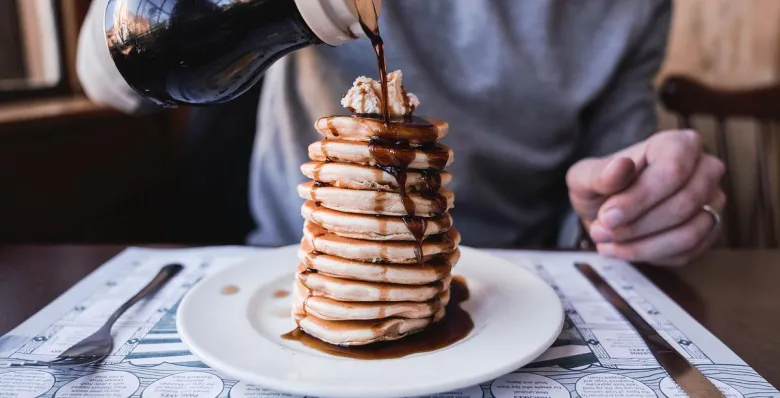 Syrup being poured over a tall stack of pancakes at the Pancake Pantry in Gatlinburg.