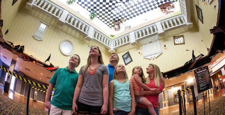 A family looks up in amazement inside the upside-down lobby of WonderWorks Gatlinburg.